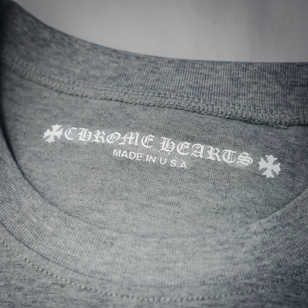 Neckline label text: brand name and "MADE IN U.S.A." on heather gray T-shirt