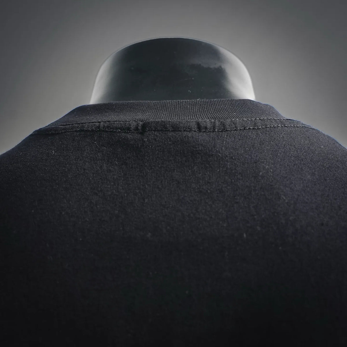 Black T-shirt crew neck collar close-up, ribbed knit trim