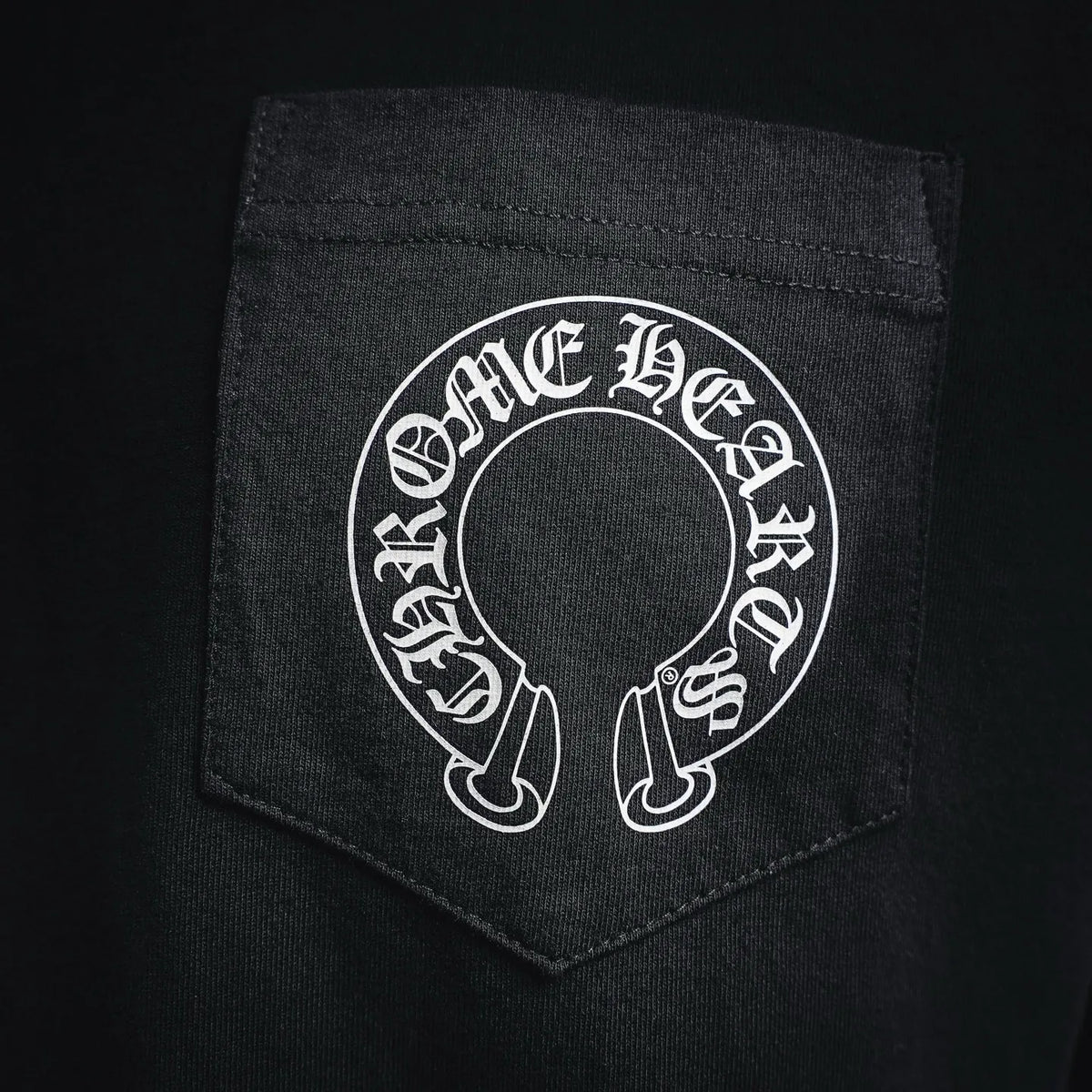 Black T-shirt chest pocket with circular Chrome Hearts logo
