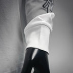 White T-shirt sleeve cuff with partial black graphic print
