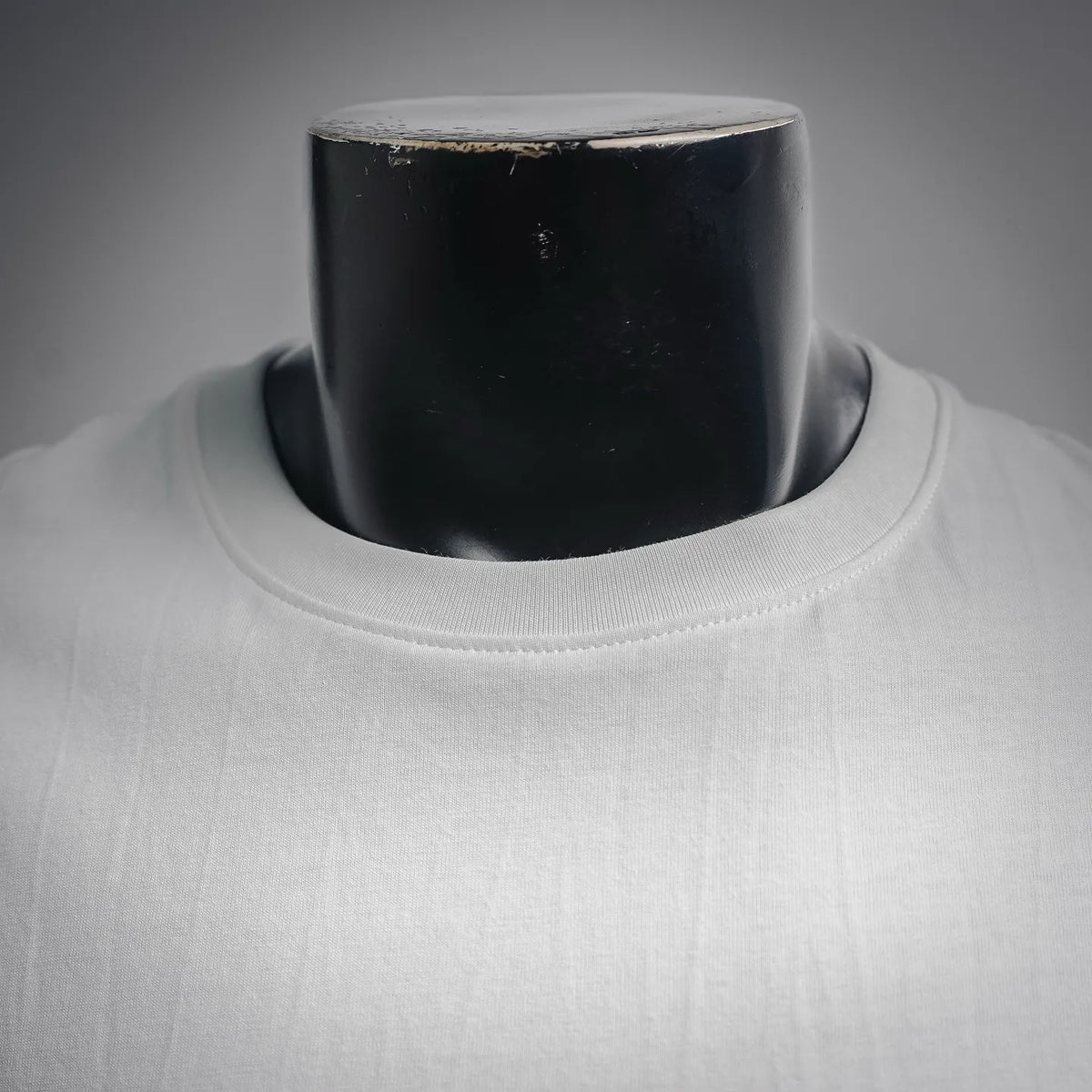 Close-up of white crew neckline on a long-sleeve T-shirt