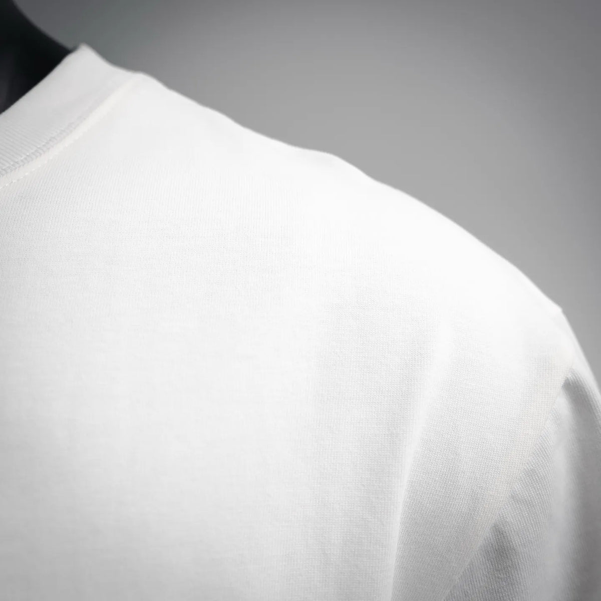 White short-sleeve T-shirt shoulder with smooth knit fabric and stitched seam detail