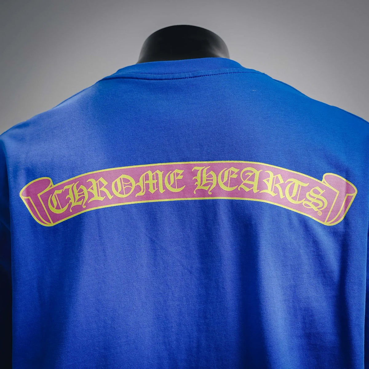 Blue short-sleeve T-shirt with large arched graphic print across the back