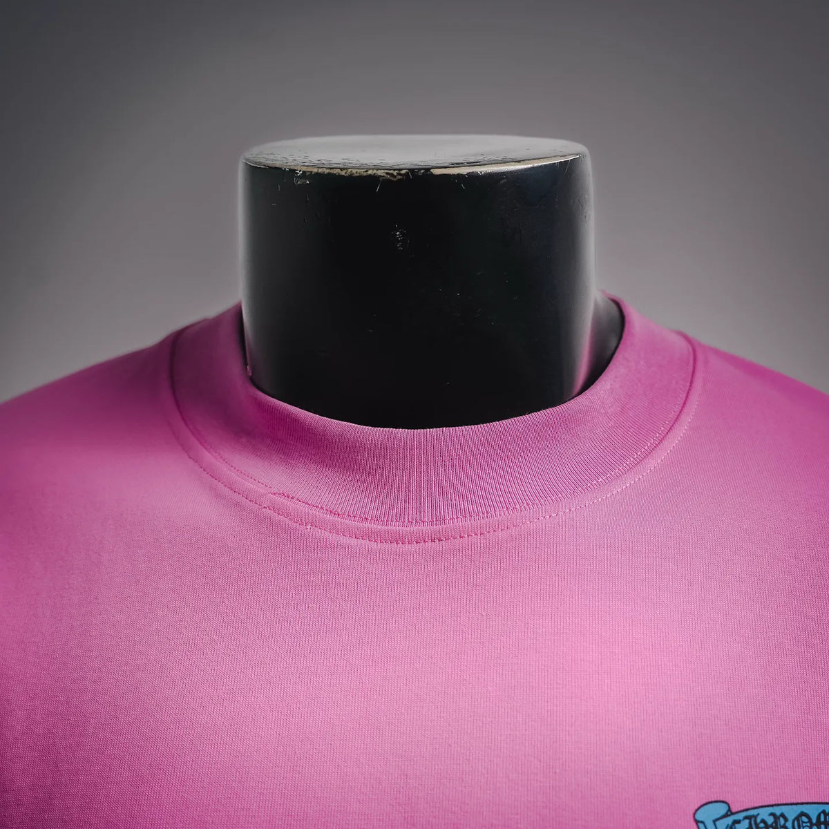 Pink crew-neck T-shirt collar with visible stitching