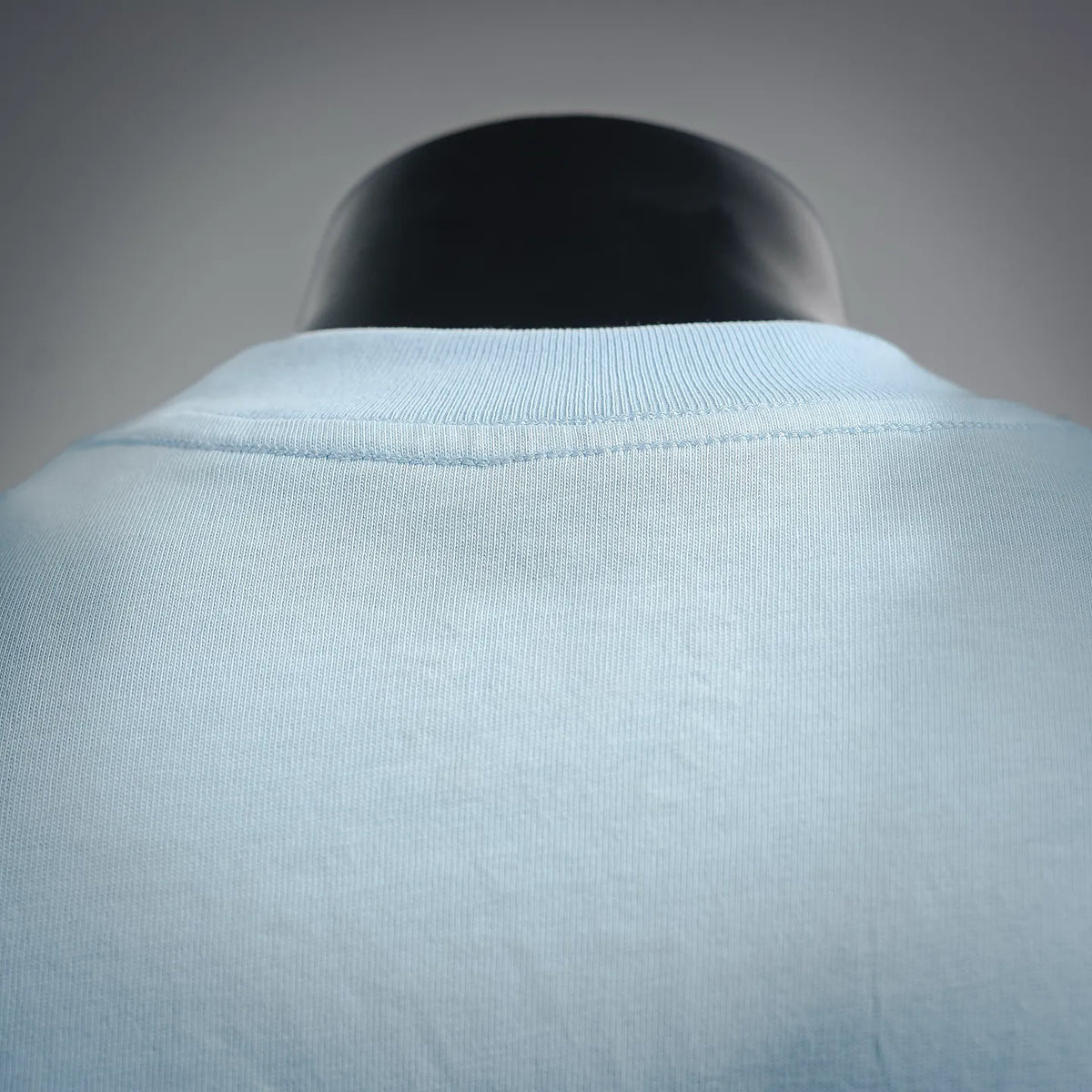 Light blue T-shirt collar and back neckline seam close-up