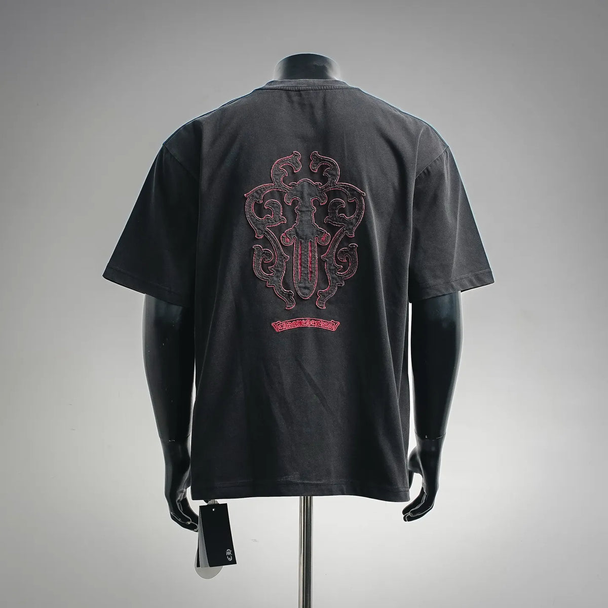 Black crewneck short-sleeve T-shirt with large red crest embroidery on back