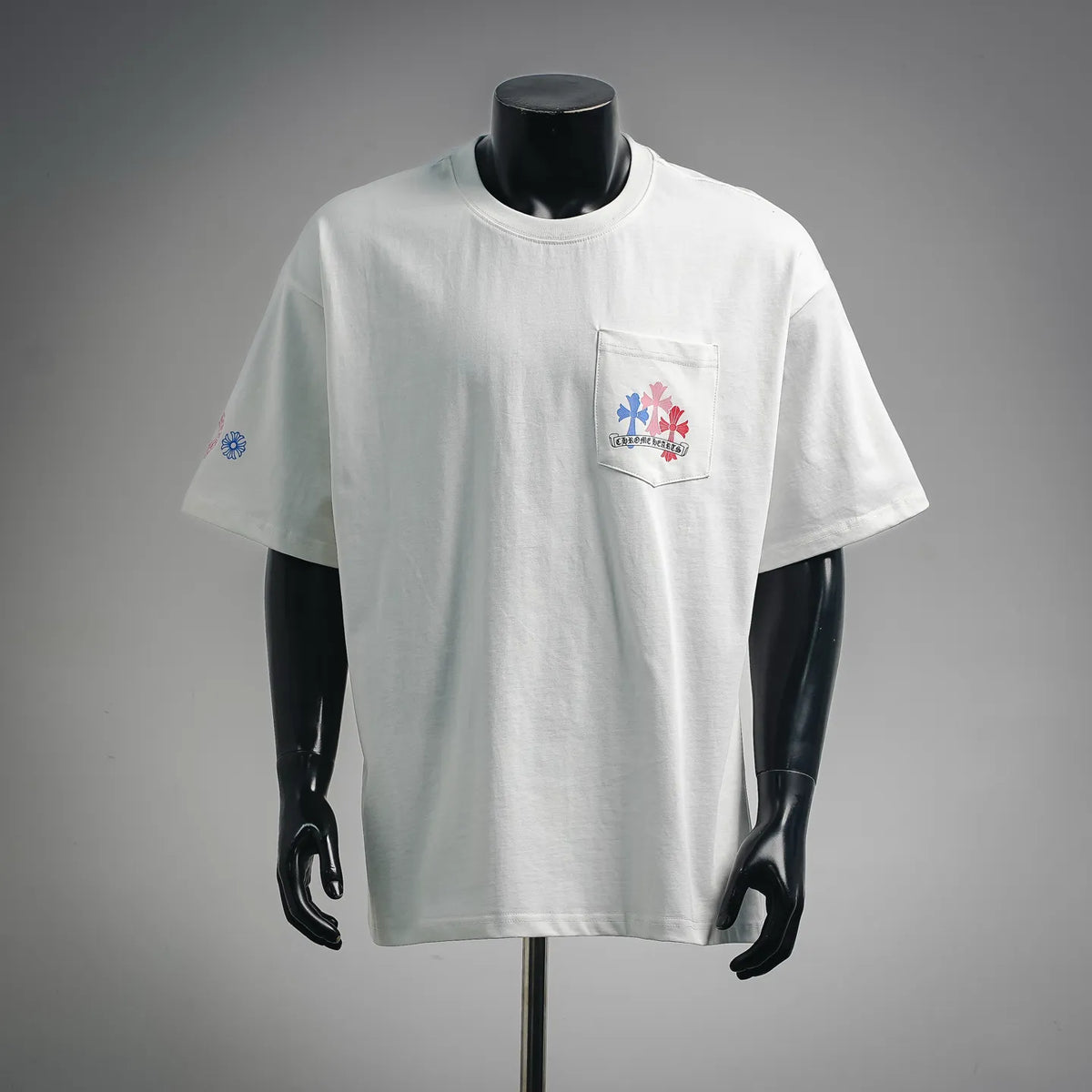 White graphic T-shirt with chest pocket logo and small sleeve emblem