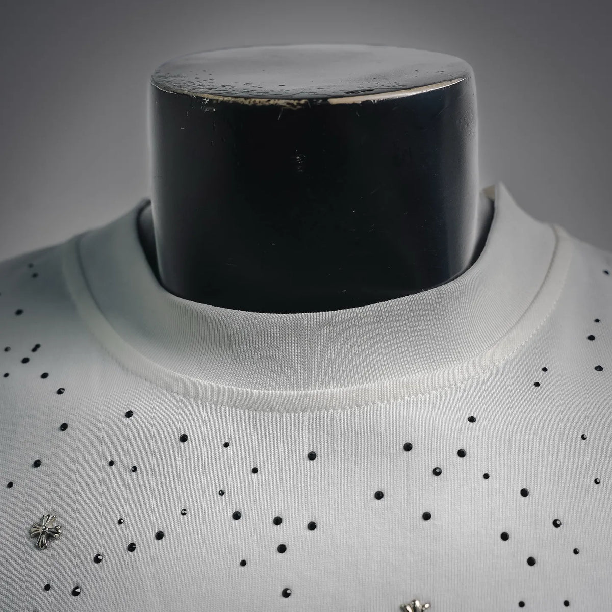 White crew-neck collar with small black bead studs and rhinestone cross details