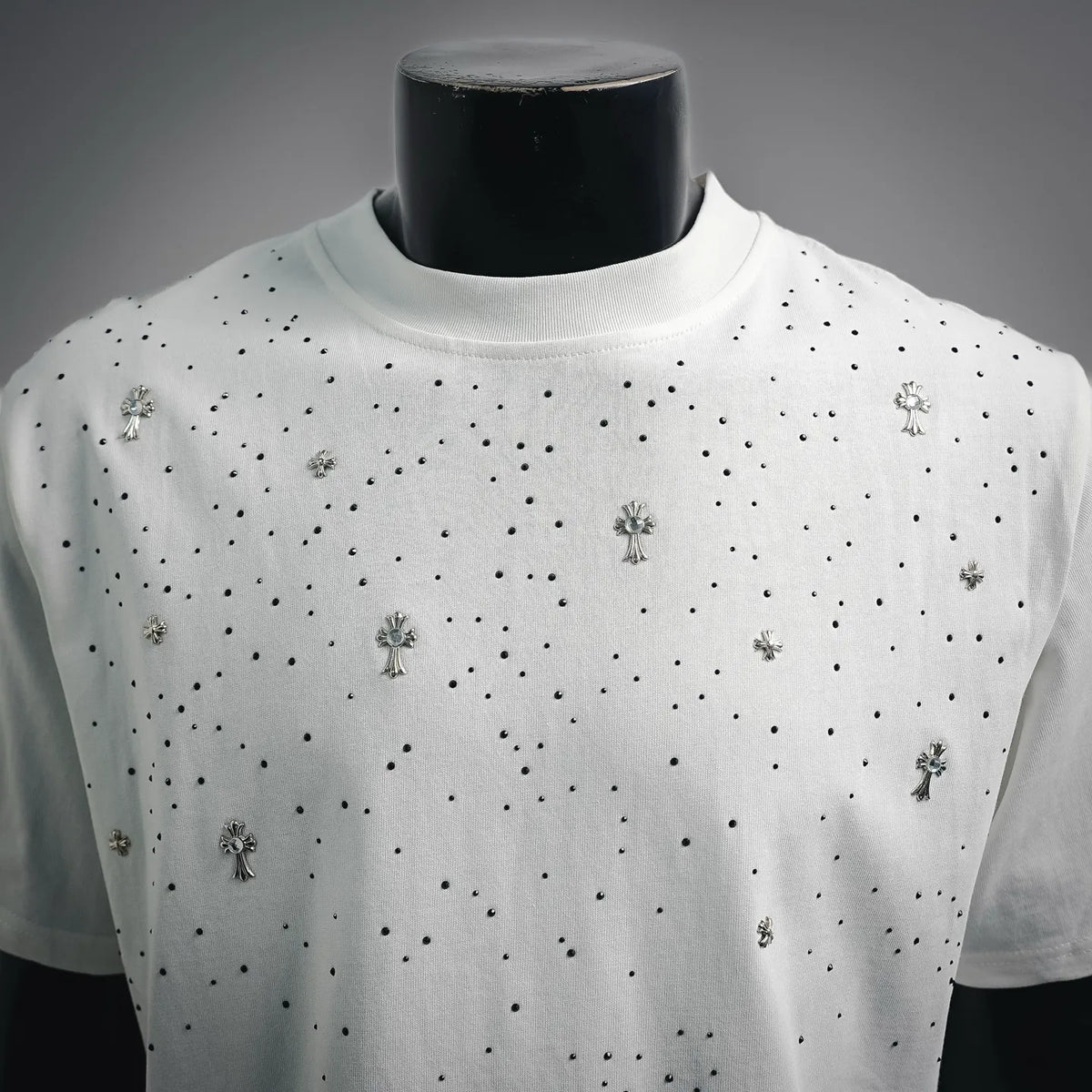 White short-sleeve T-shirt front with scattered rhinestone cross charms and black dots