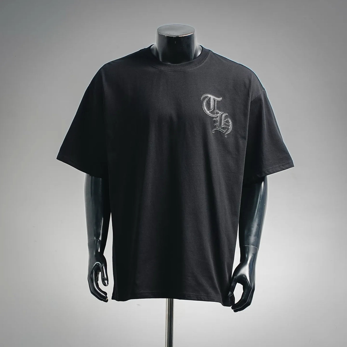 Black short-sleeve T-shirt with embroidered crest logo on left chest