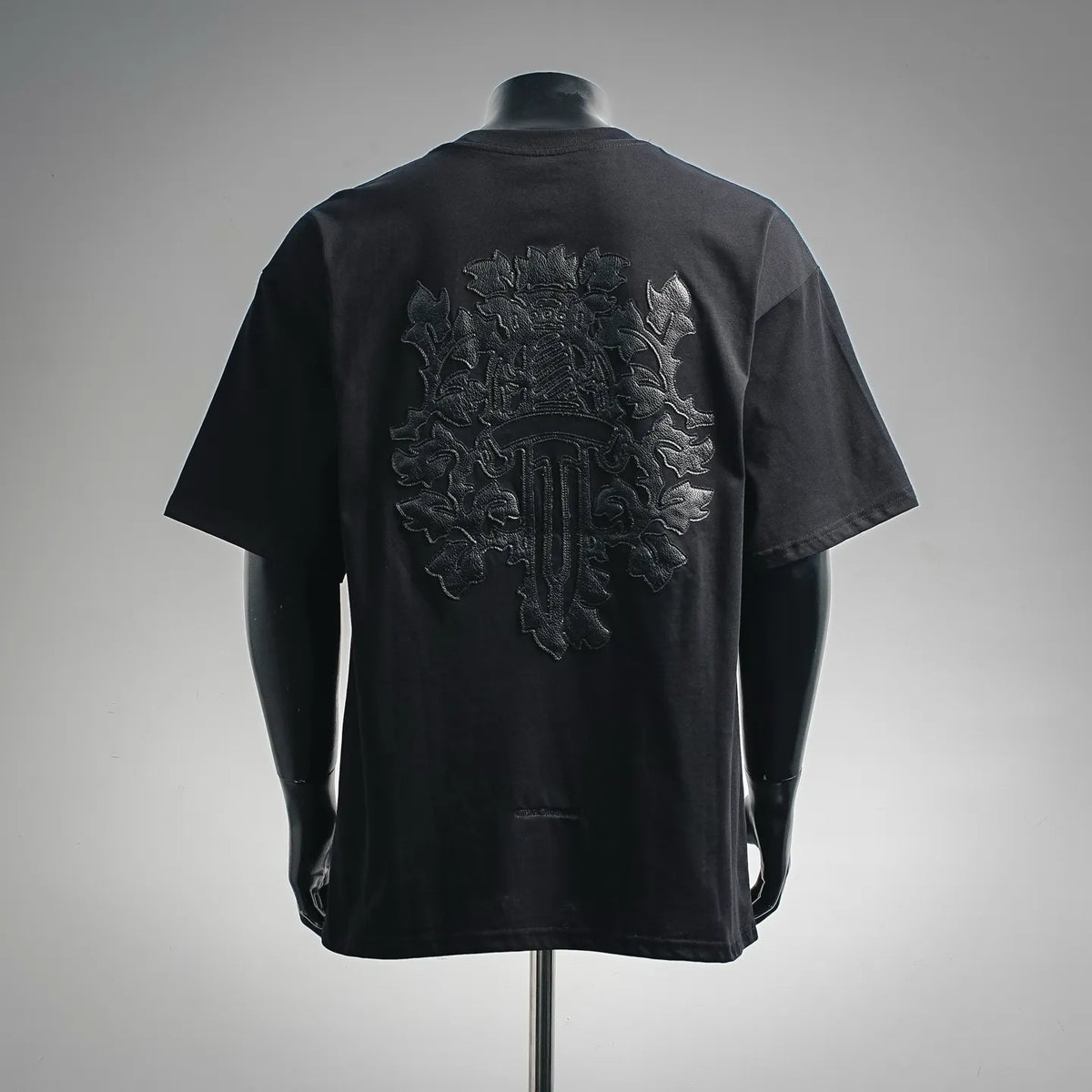 Black short-sleeve T-shirt with large embroidered crest on the back