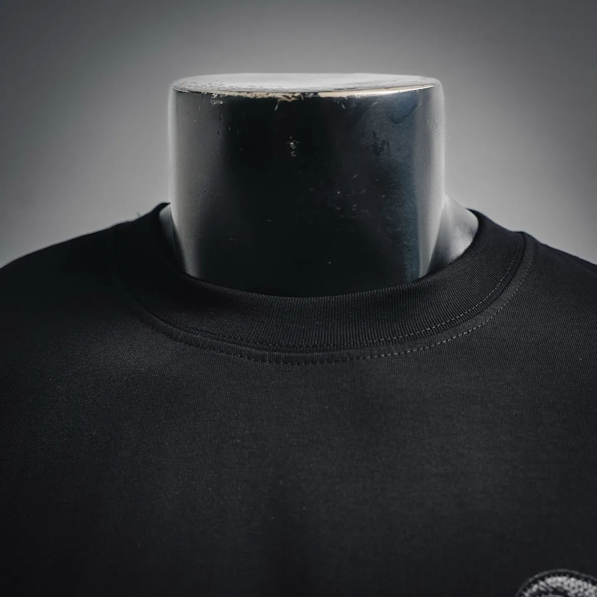 Black crew-neck T-shirt with ribbed neckline and clean collar seam