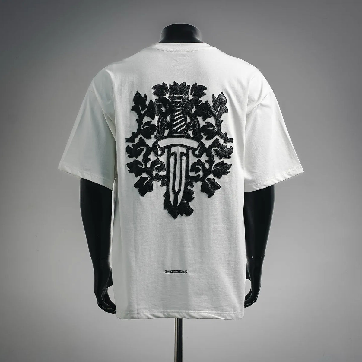 White crewneck T-shirt with large black back graphic and central emblem