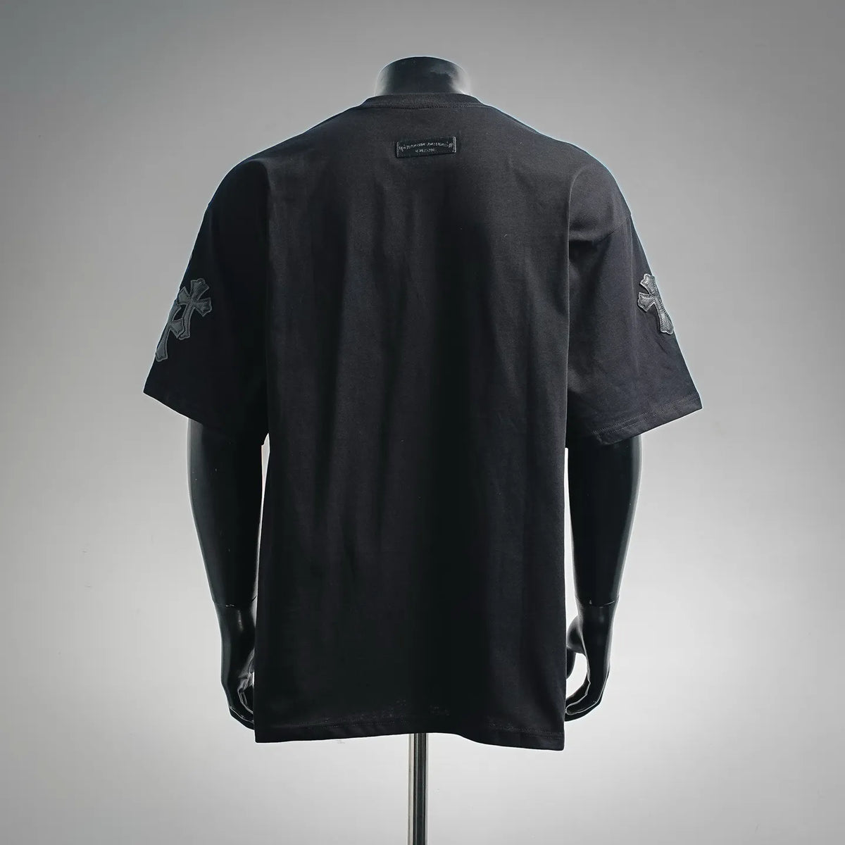 Black short-sleeve crewneck T-shirt with cross graphics on the sleeves and back
