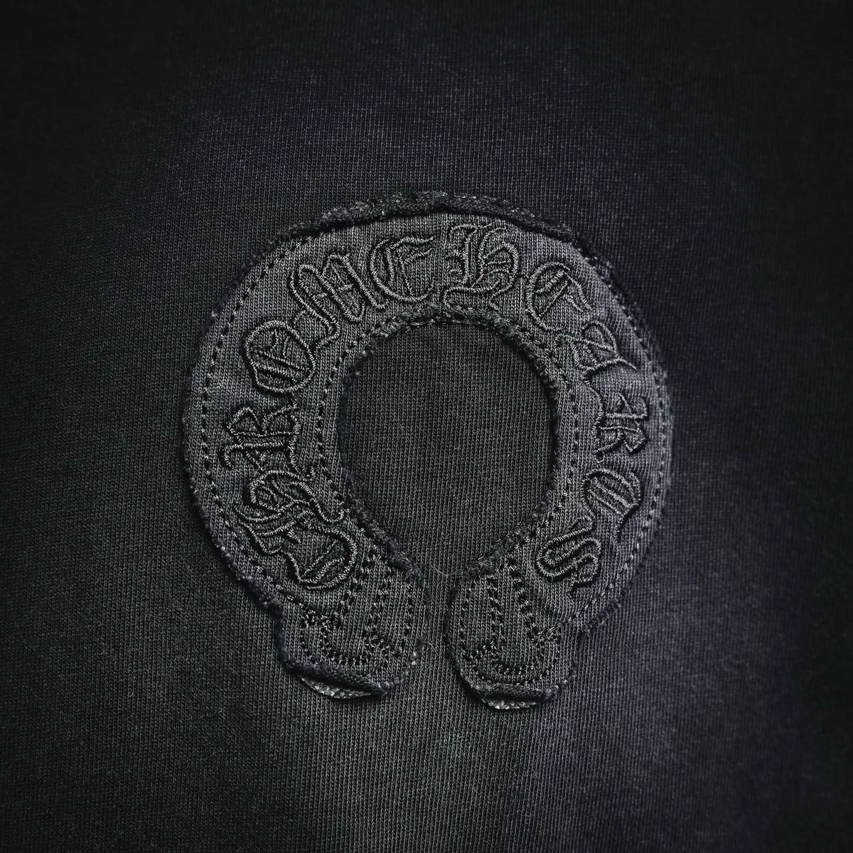 Black T-shirt logo patch embroidery with decorative oval outline