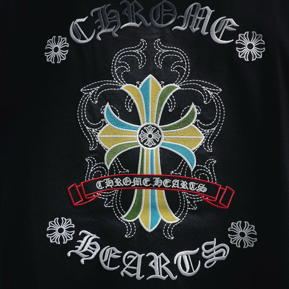 Black T-shirt close-up of multicolor floral cross logo on back