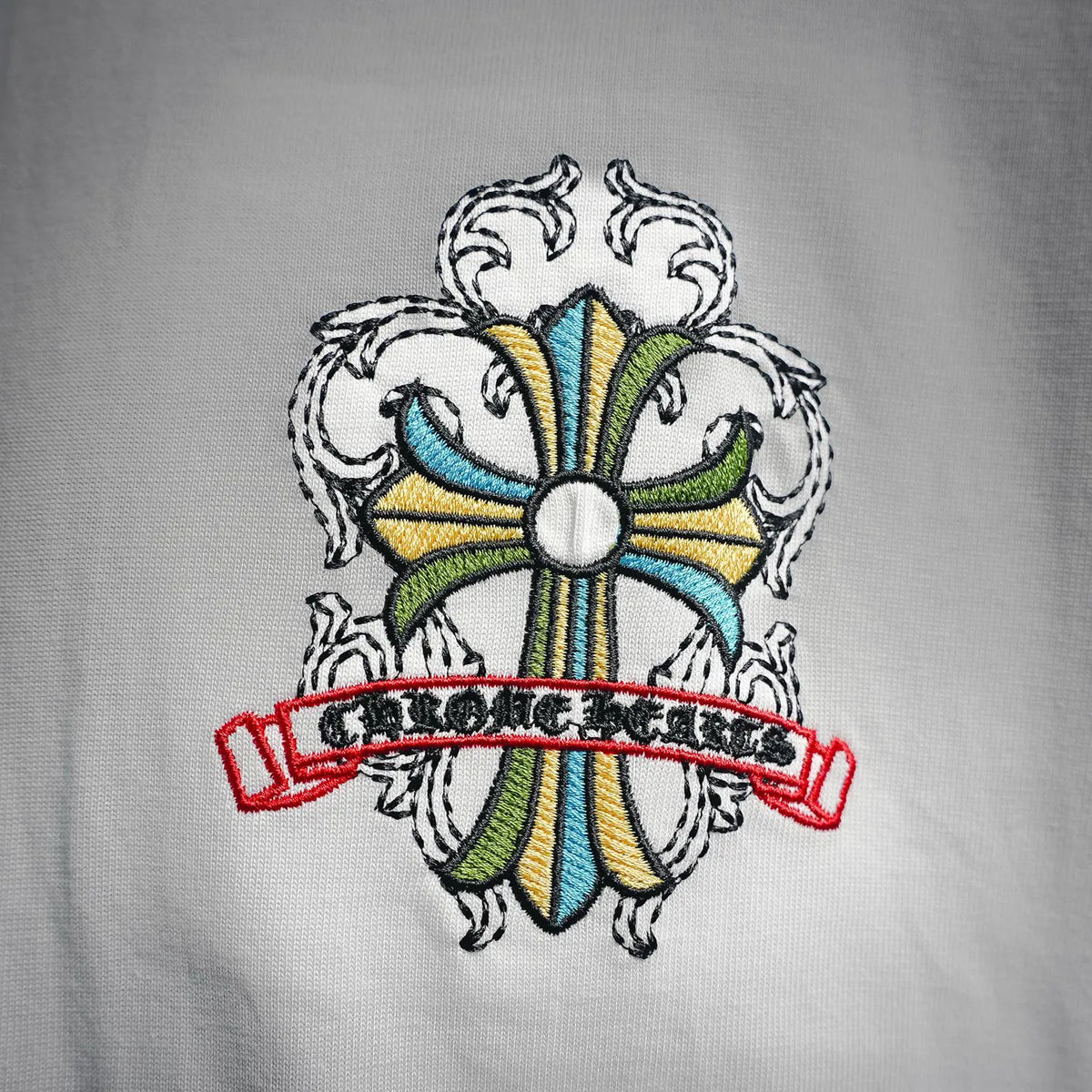 White T-shirt front logo patch with multicolor banner graphic
