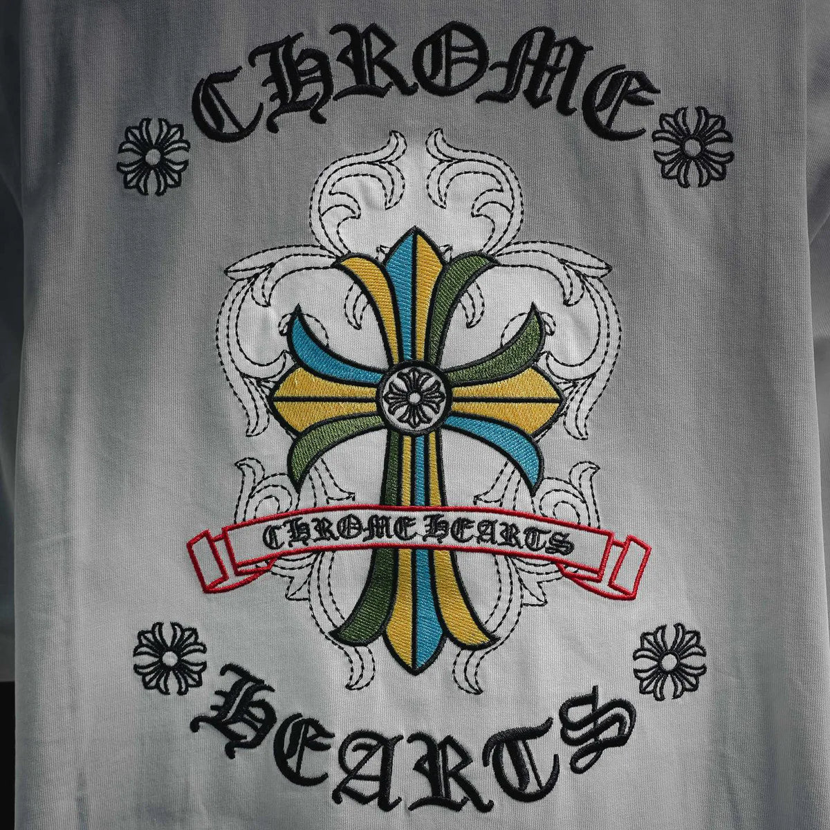 White T-shirt back graphic with colorful emblem and banner text