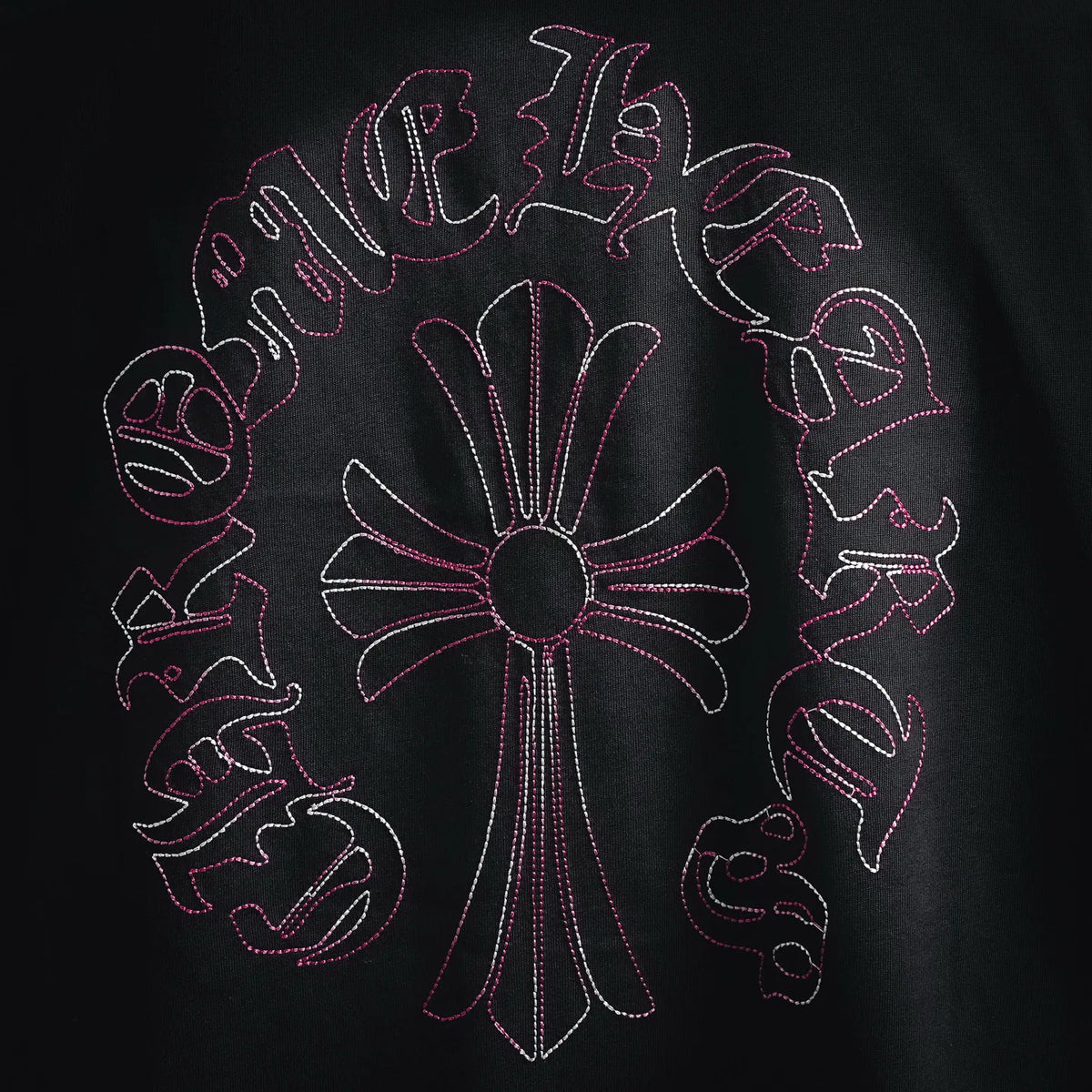 Black T-shirt front with full pink-and-white embroidered-style circular graphic