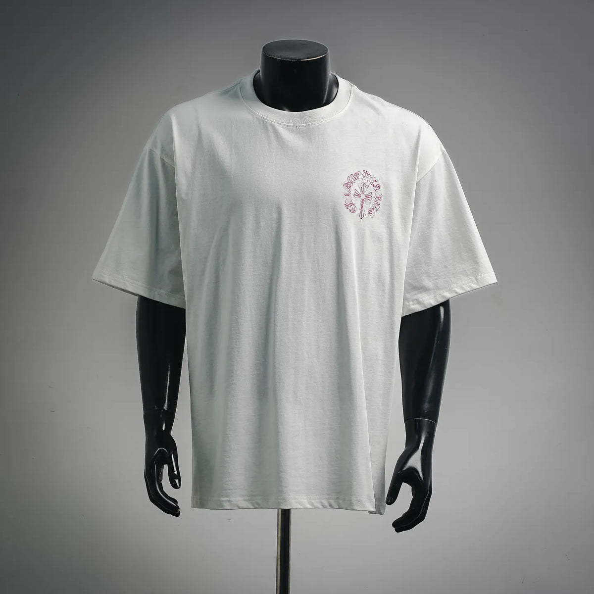 White short-sleeve T-shirt with small pink embroidered flower at chest