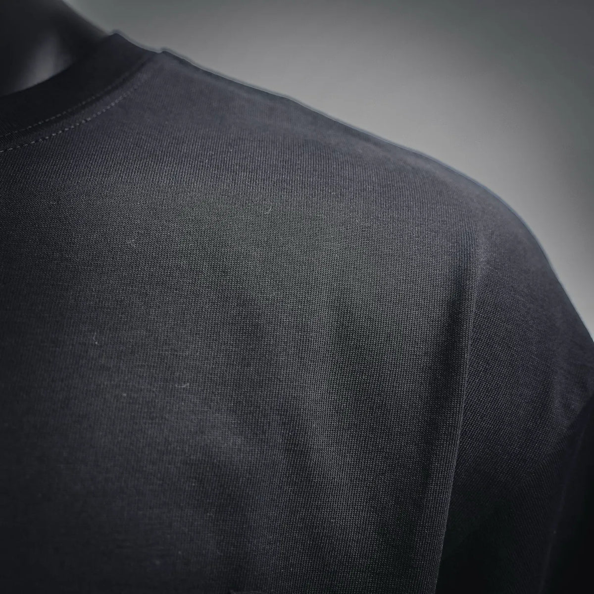 Men's black short-sleeve T-shirt fabric view with smooth crew neckline