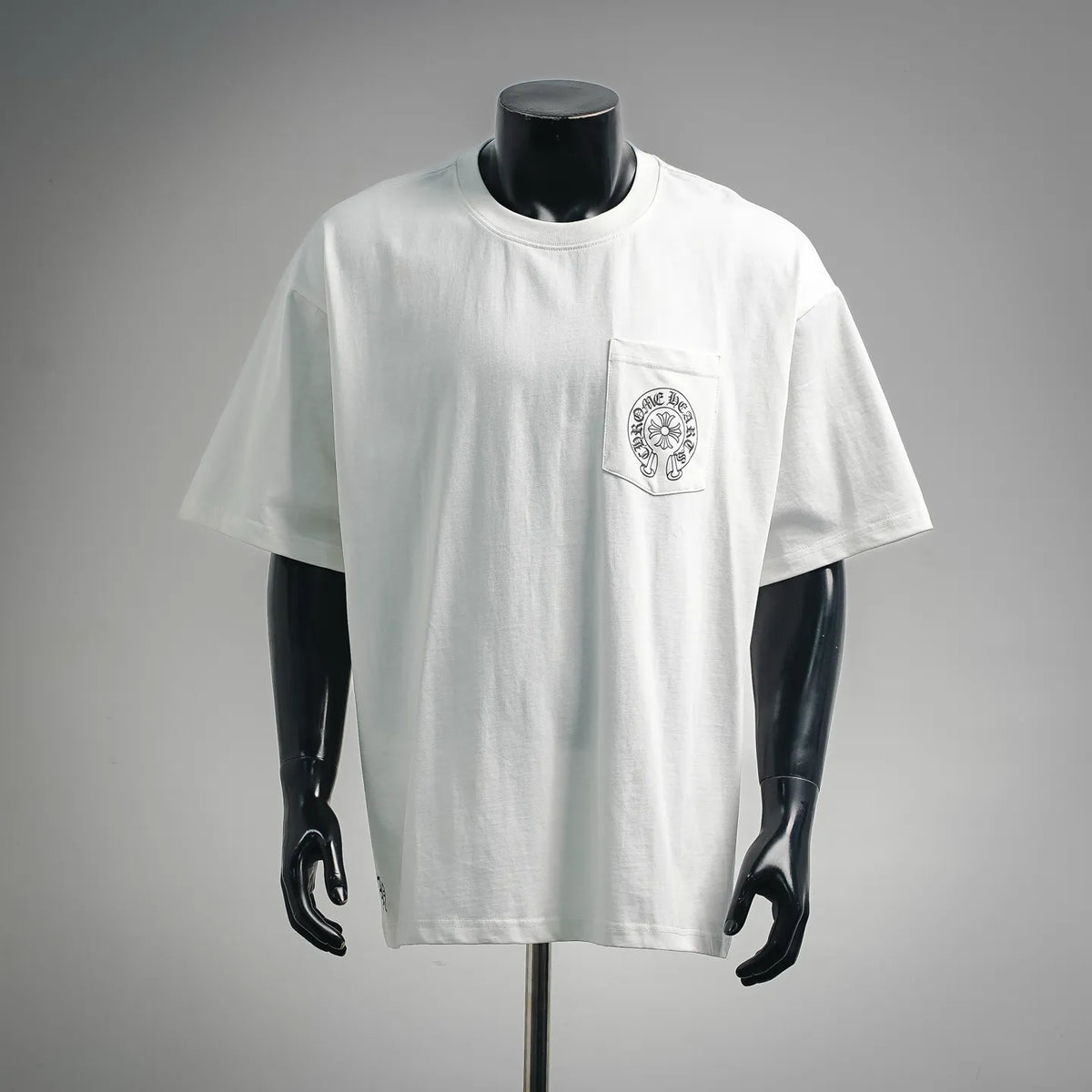 White graphic T-shirt with crew neck and left chest emblem