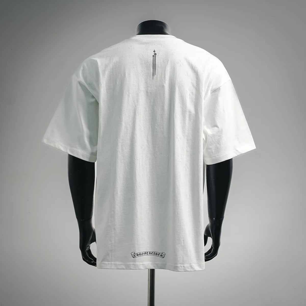White graphic T-shirt back view with vertical cross print near center