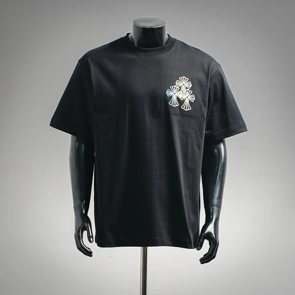 Black crewneck T-shirt with small multicolor embroidered flower graphic on left chest