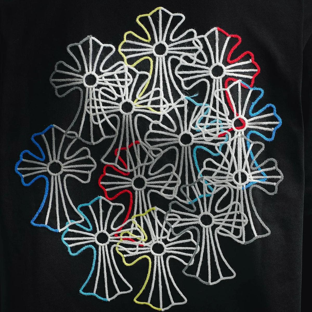 Close-up of multicolor embroidered flower graphic on black T-shirt