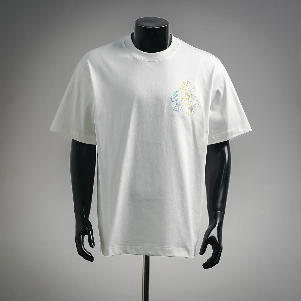 White crew-neck T-shirt with small multicolor embroidered graphic on left chest