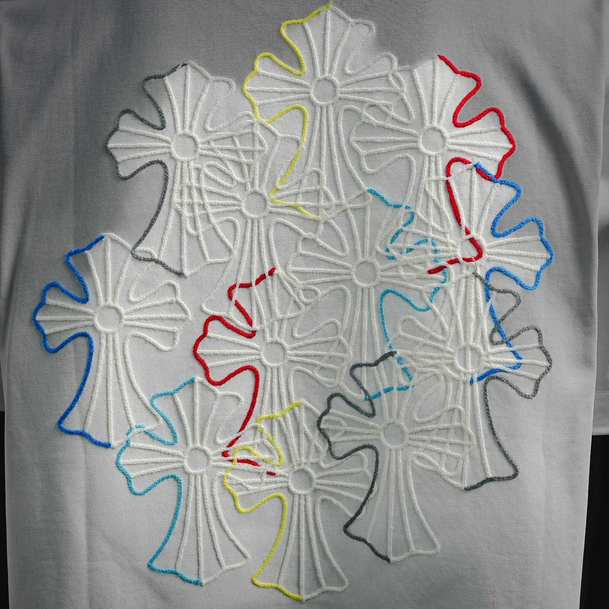 White T-shirt back with multicolor embroidered snowflake-style graphic