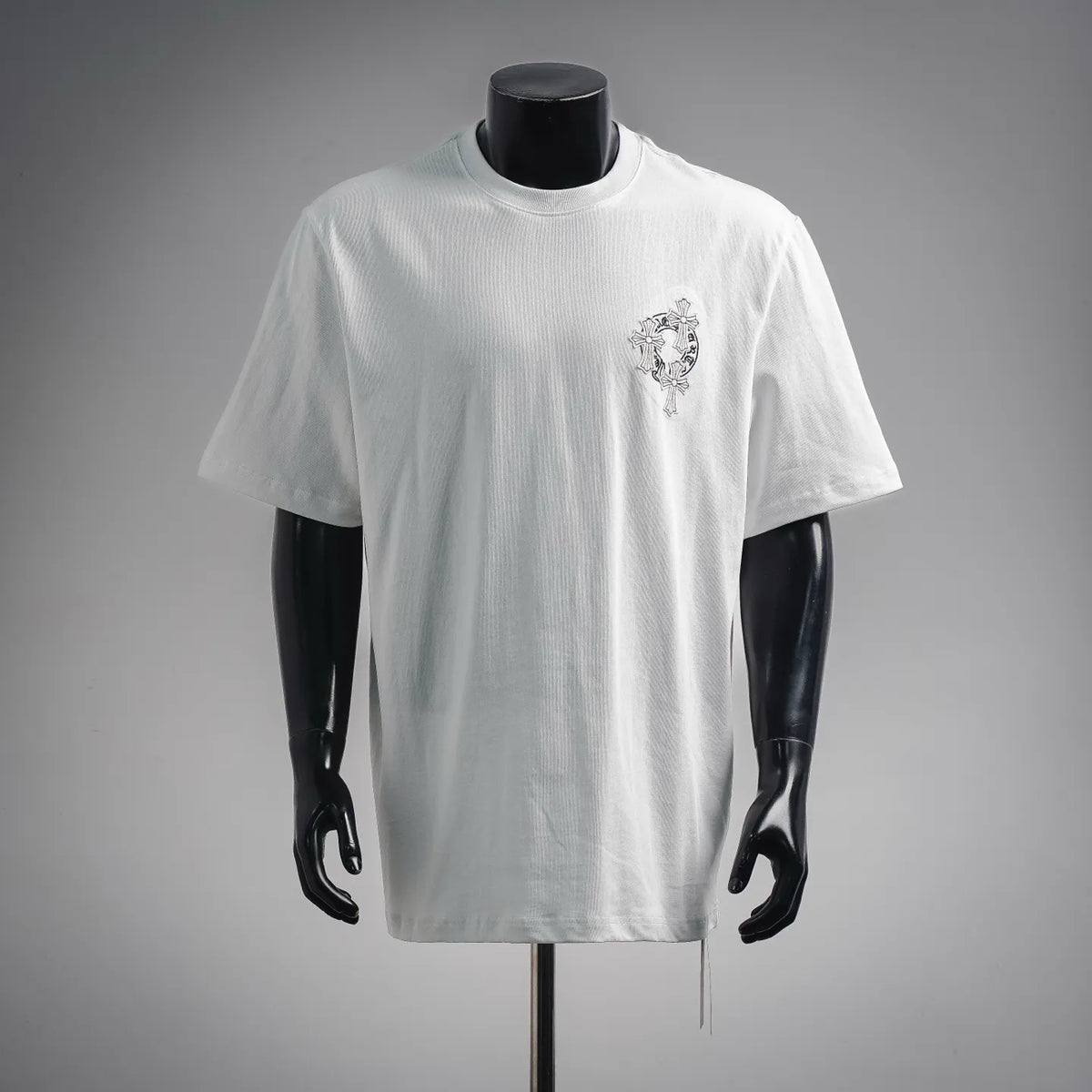 White crew-neck short-sleeve T-shirt with small embroidered cross emblem on chest