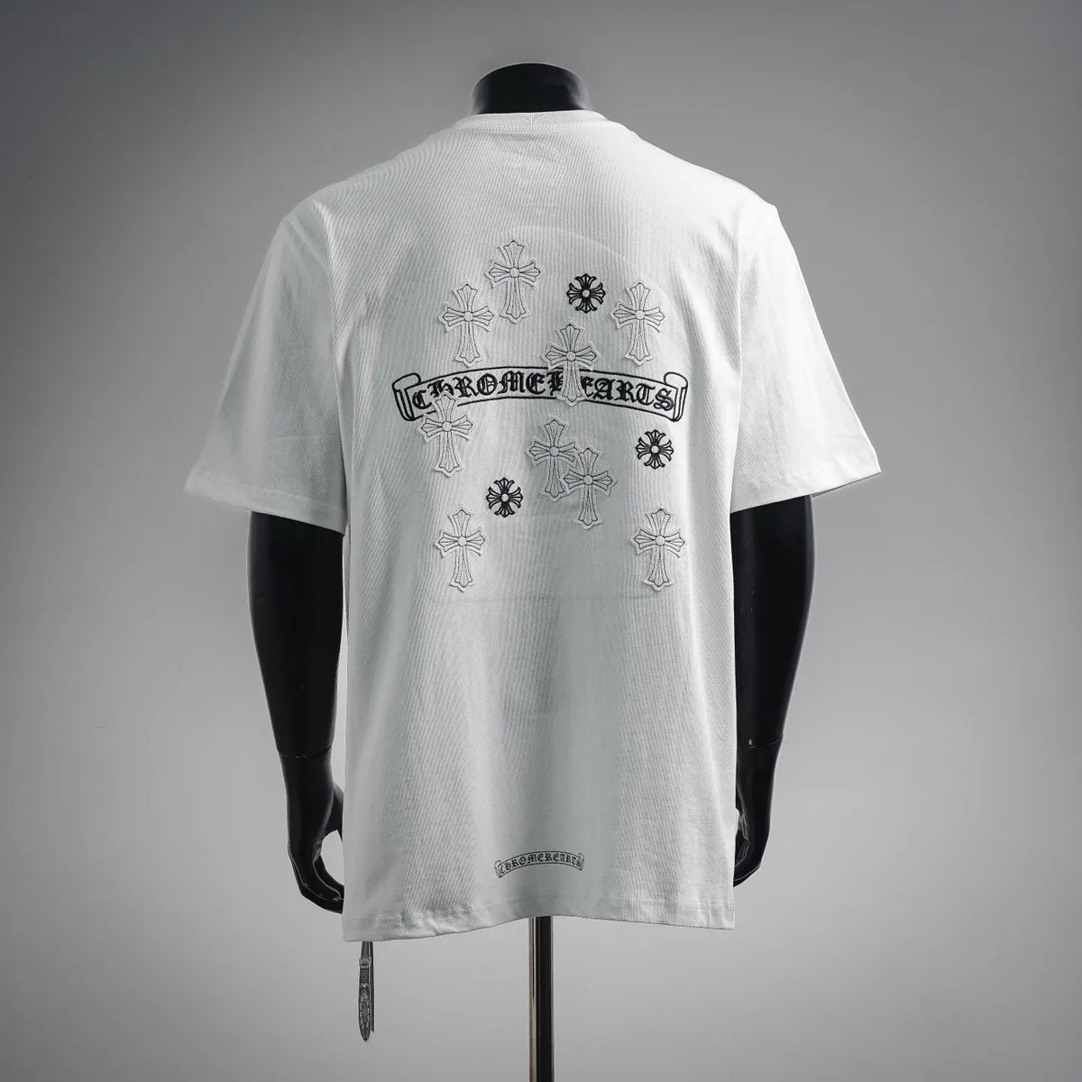 White crew-neck short-sleeve T-shirt with back graphic text and cross motifs