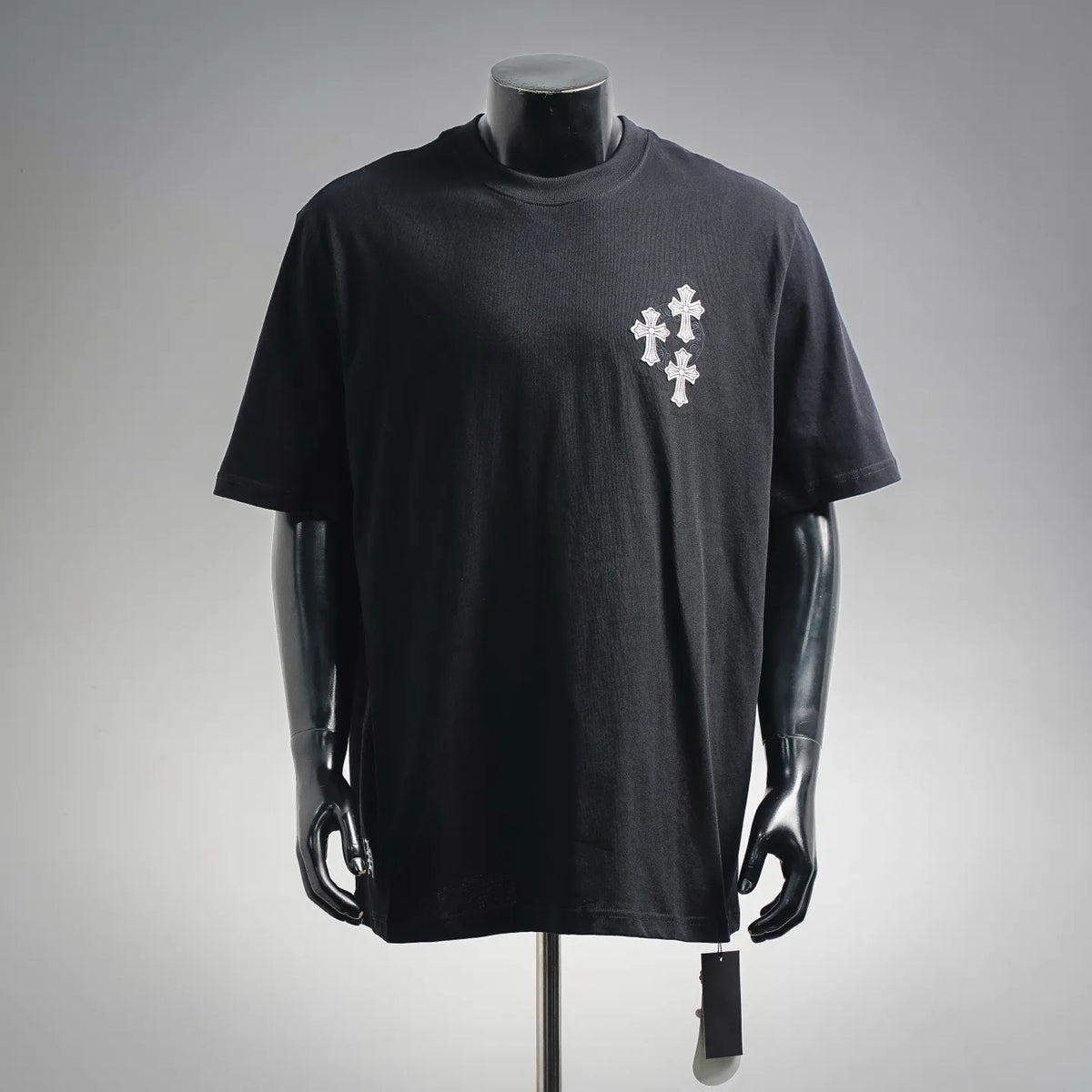 Black crewneck T-shirt with white cross emblem on the front chest