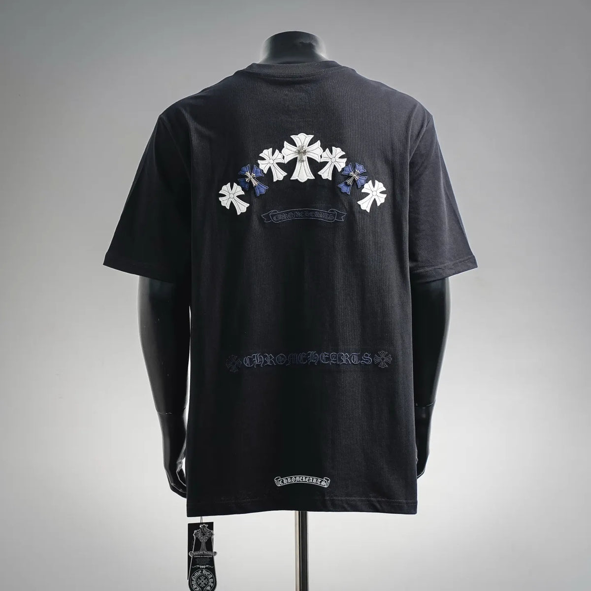 Black crewneck T-shirt with large white cross graphic and blue accents on the back
