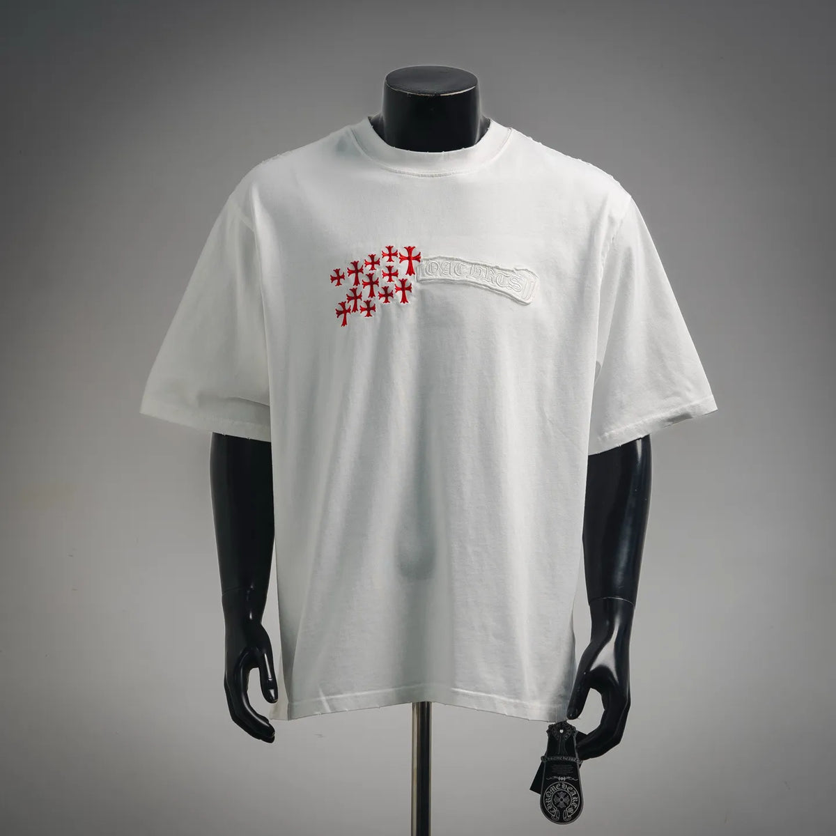 White short-sleeve T-shirt with red cross graphic and embossed white design