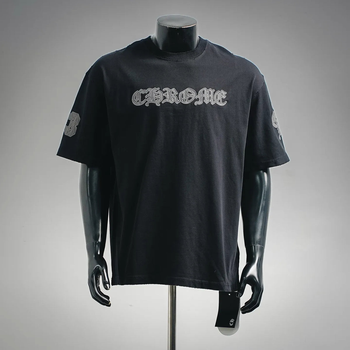 Black crewneck T-shirt with large front chrome-style graphic print