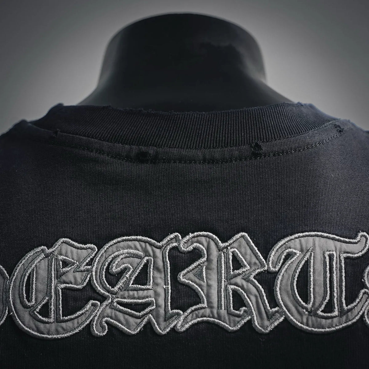 Black crewneck T-shirt collar with ribbed neckline and raised graphic stitching
