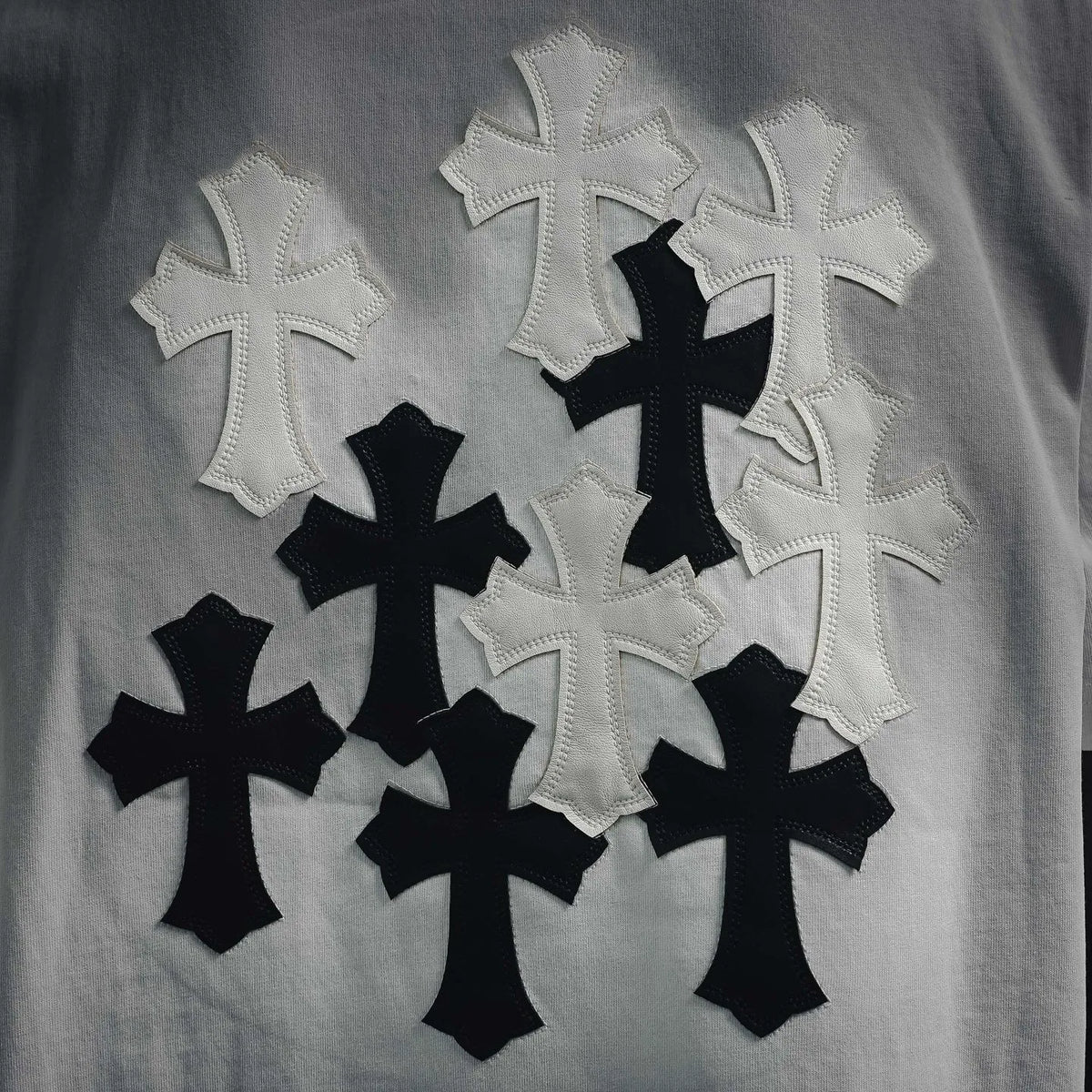 White T-shirt back with appliqued black and white cross shapes