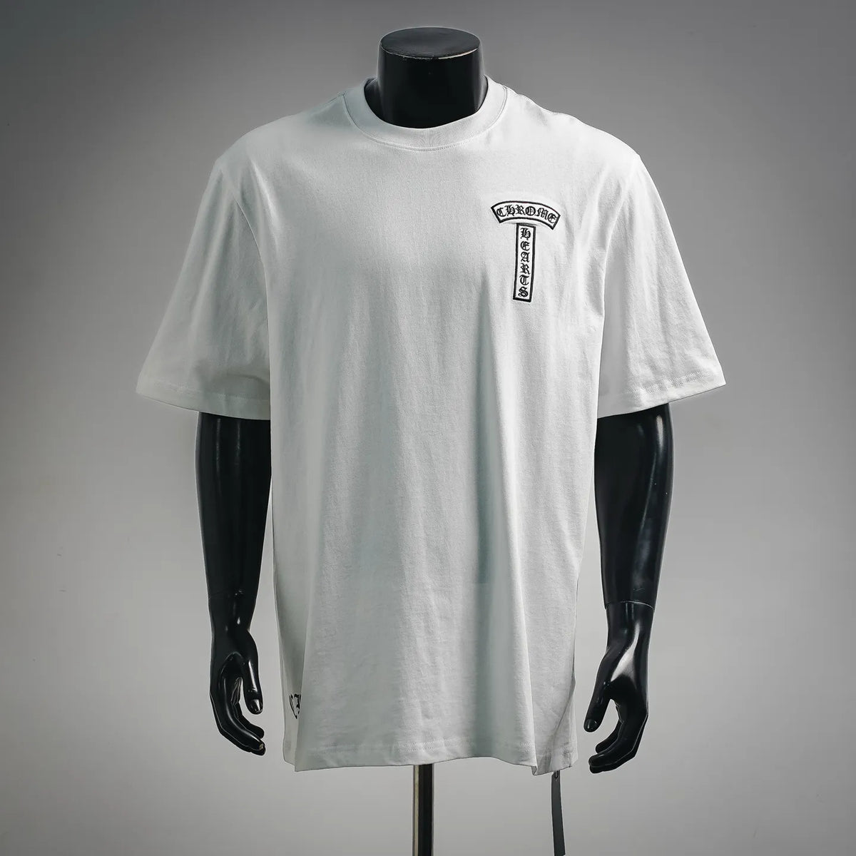 White short-sleeve T-shirt on mannequin, small chest logo print