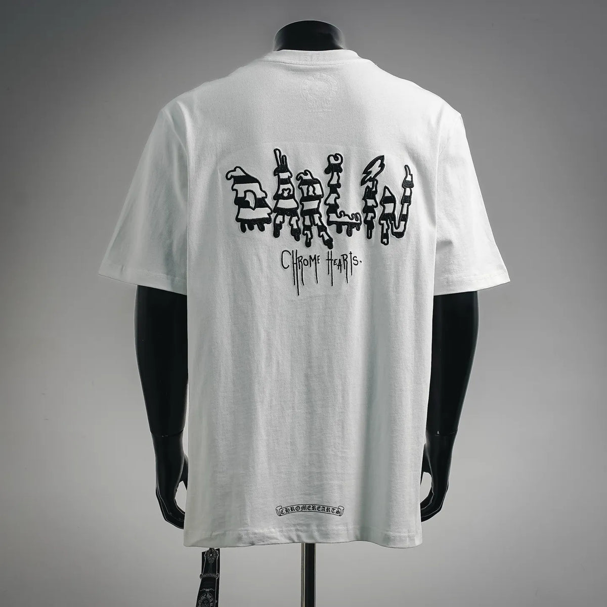 White short-sleeve T-shirt on mannequin, large back character graphic and logo