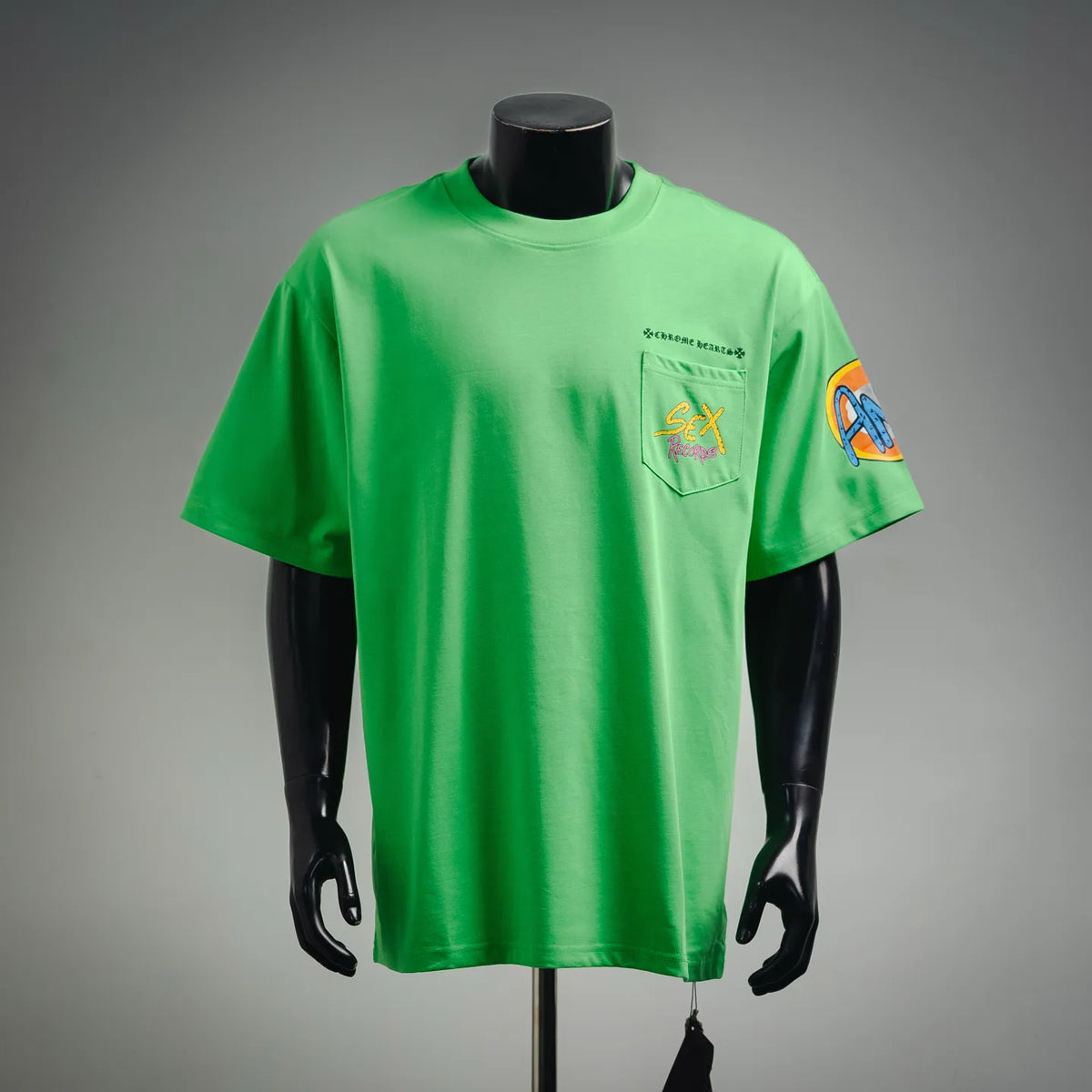 Green short-sleeve T-shirt with front chest pocket and colorful graphic logo