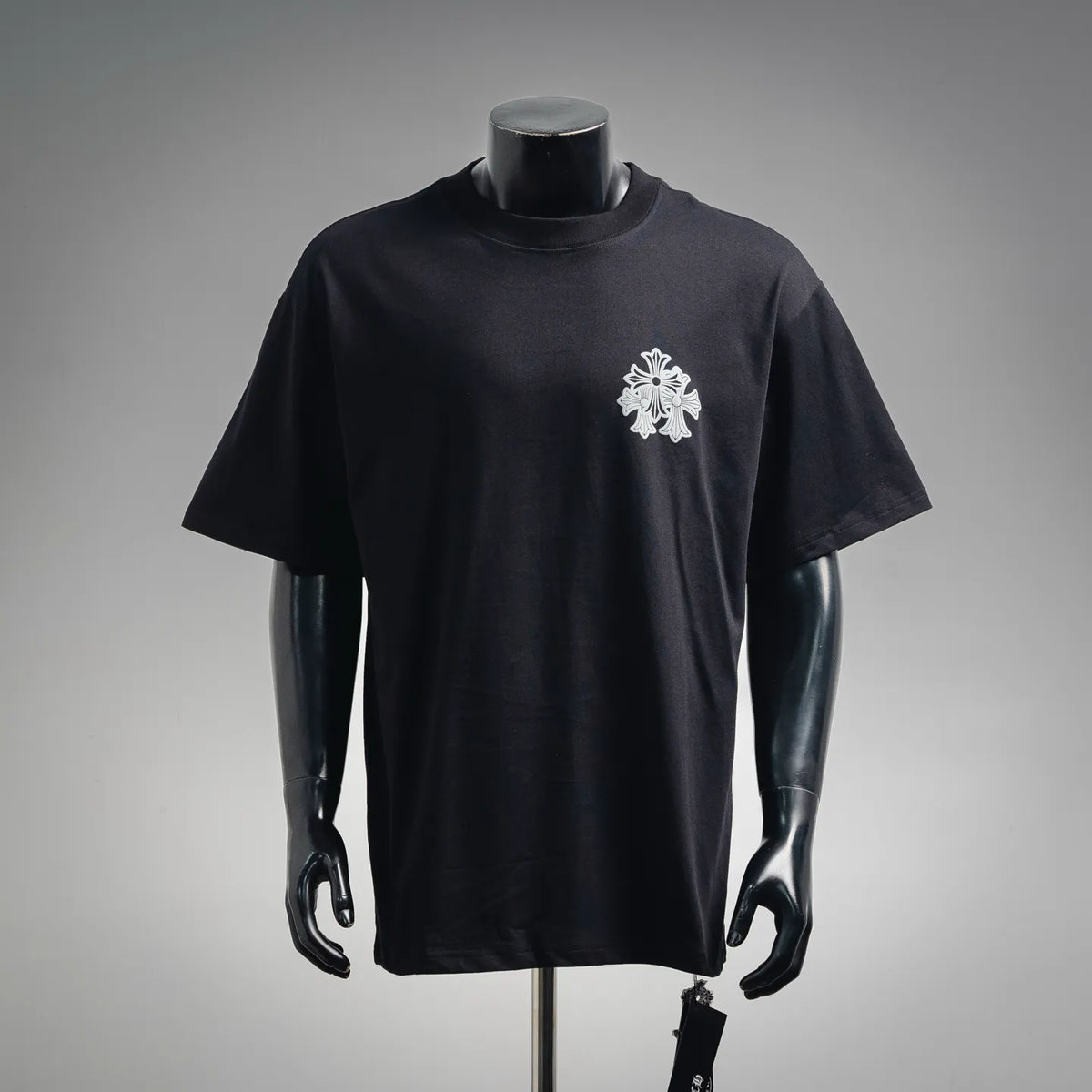Black crewneck short-sleeve T-shirt with small white crest logo on the chest