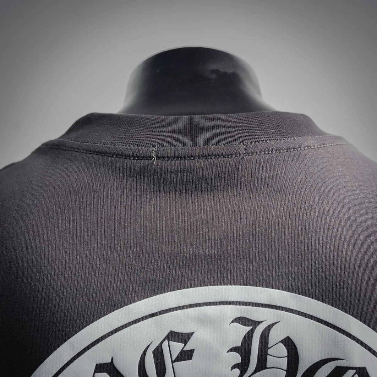 Charcoal T-shirt neckline with ribbed collar and partial white back graphic
