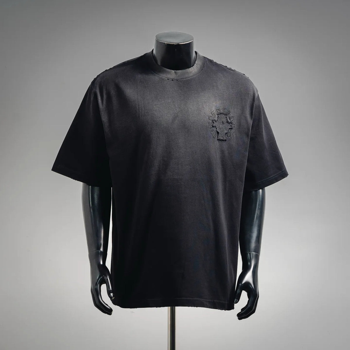 Black short-sleeve T-shirt with small embroidered crest on left chest