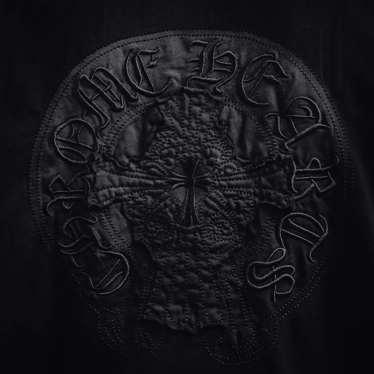 Black T-shirt large circular embroidered crest on back