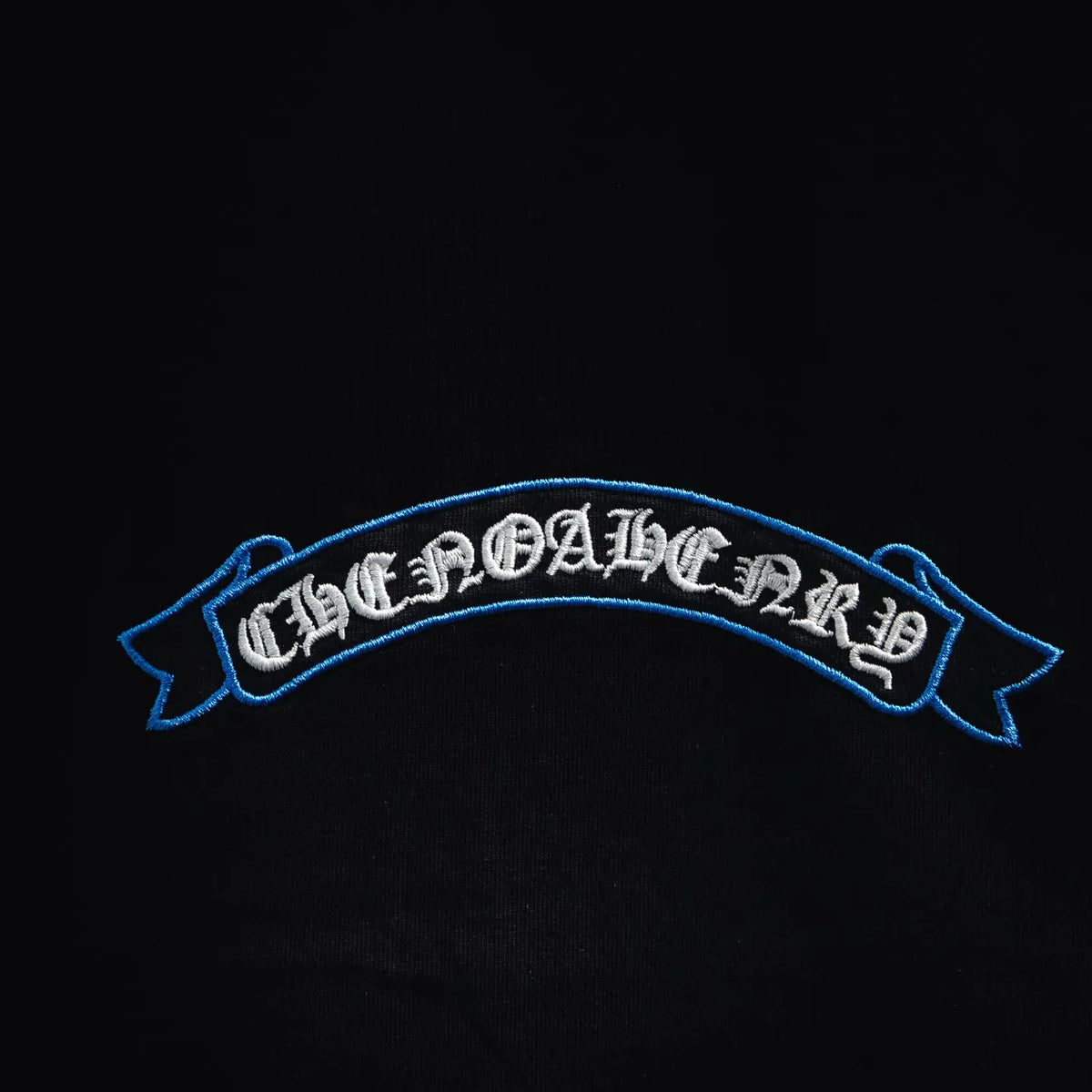 Blue embroidered ribbon logo on black T-shirt chest