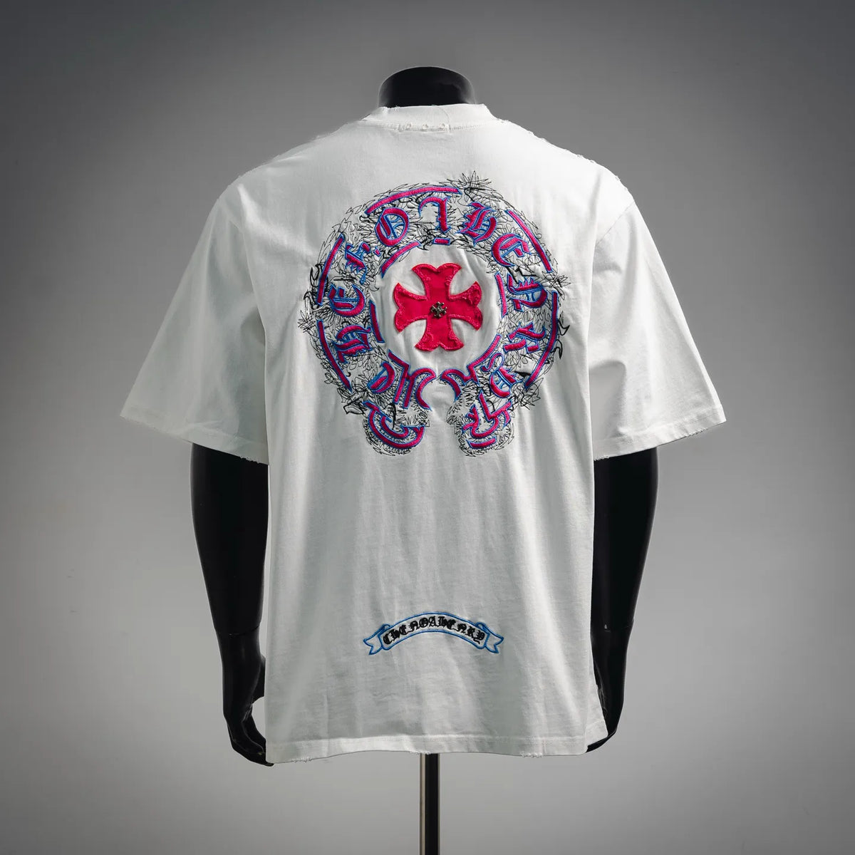 White short-sleeve T-shirt with large back embroidered graphic and a small lower back patch.