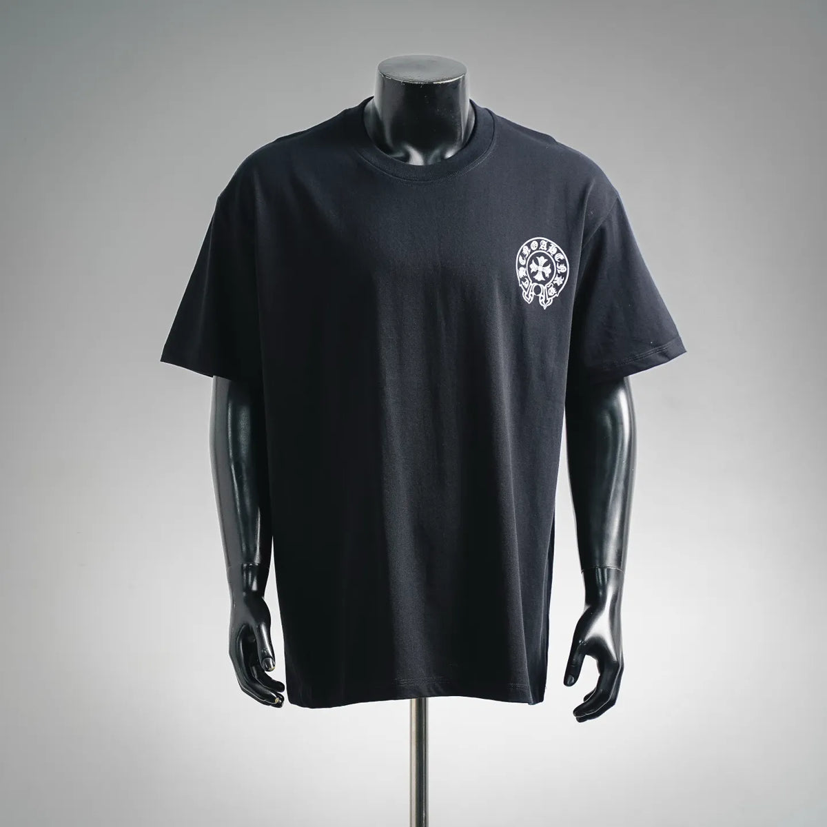 Black short-sleeve crewneck T-shirt with small white crest logo on chest