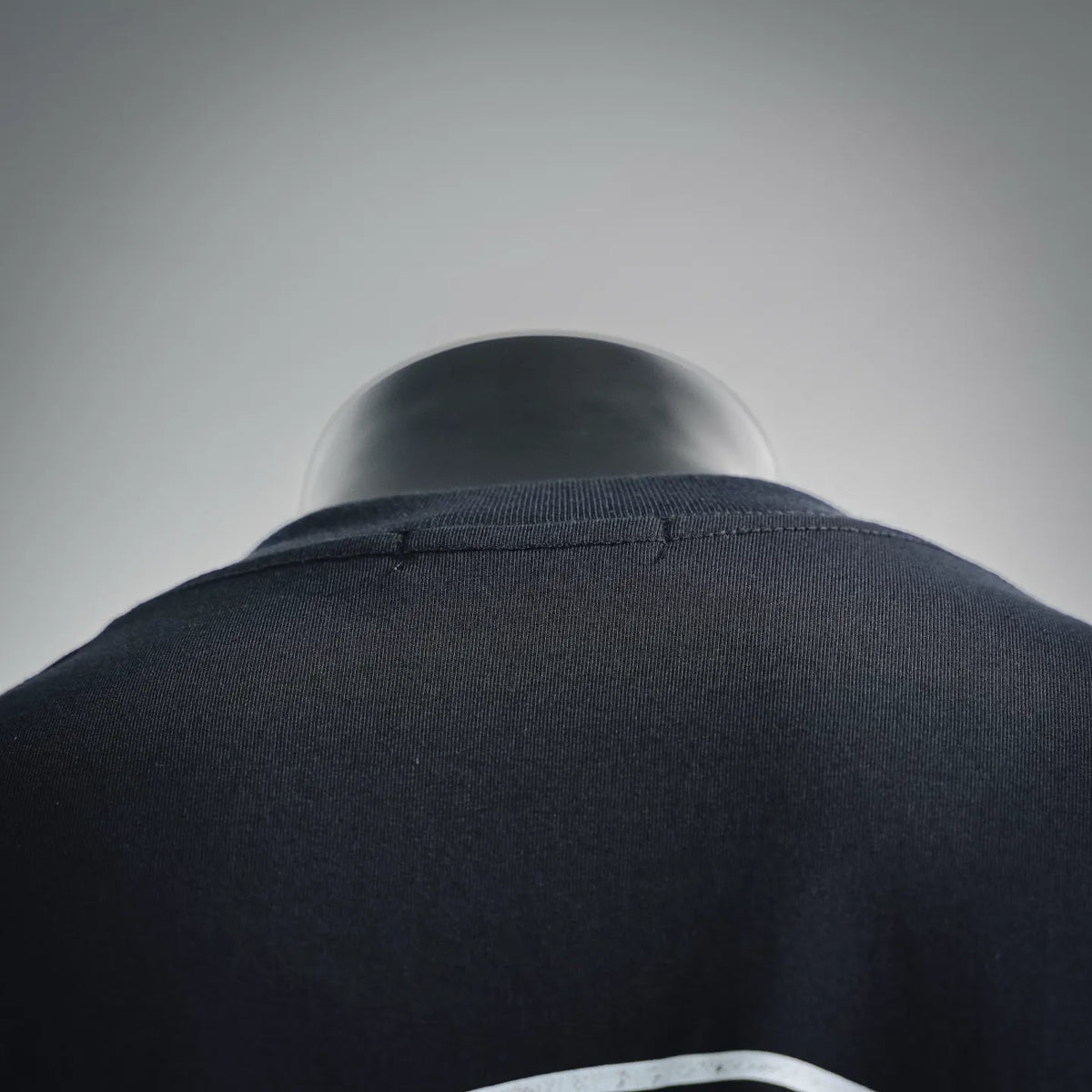 Black T-shirt shoulder and ribbed crewneck collar detail